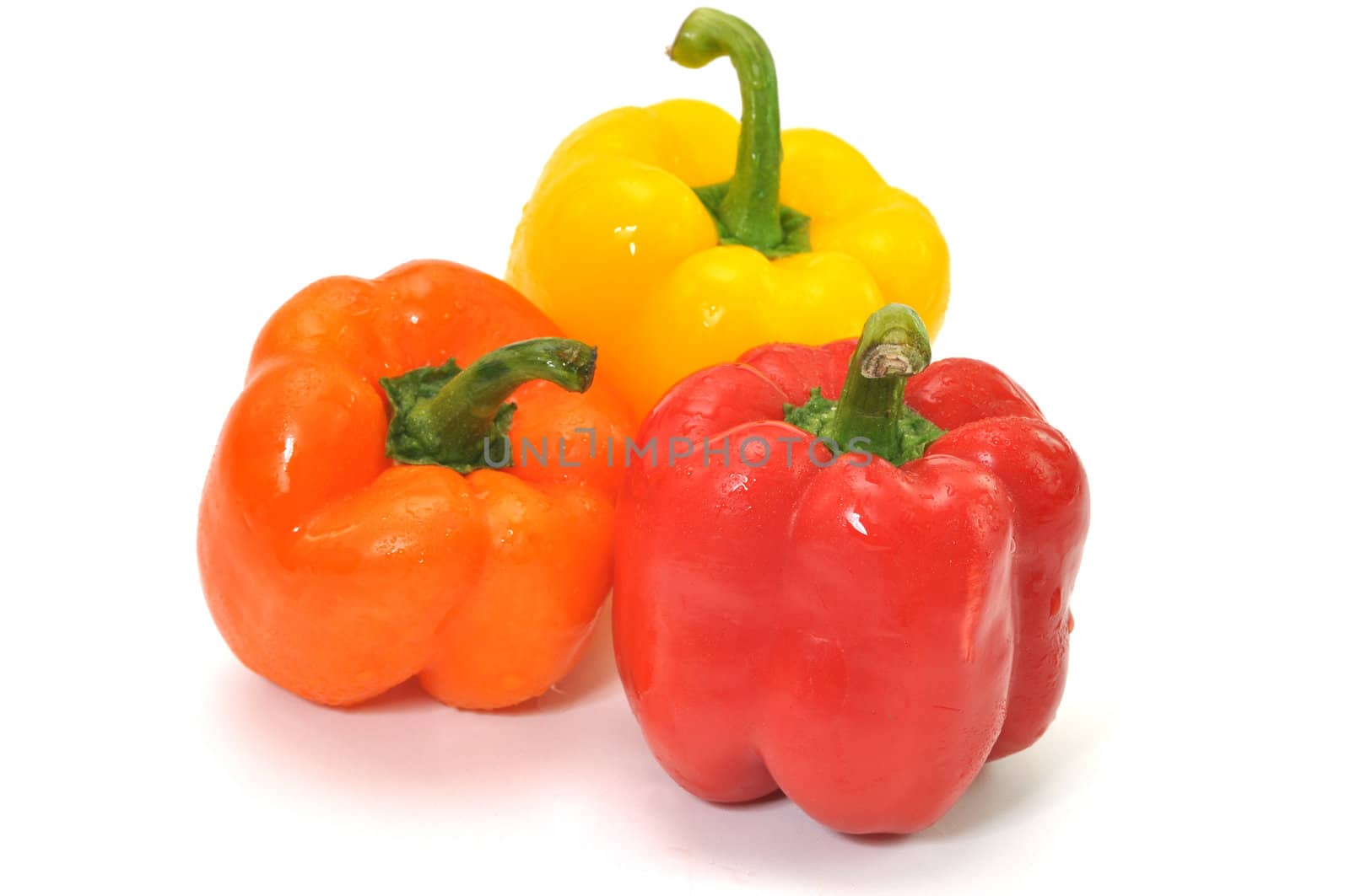Three colorful bell peppers isolated on white background.l