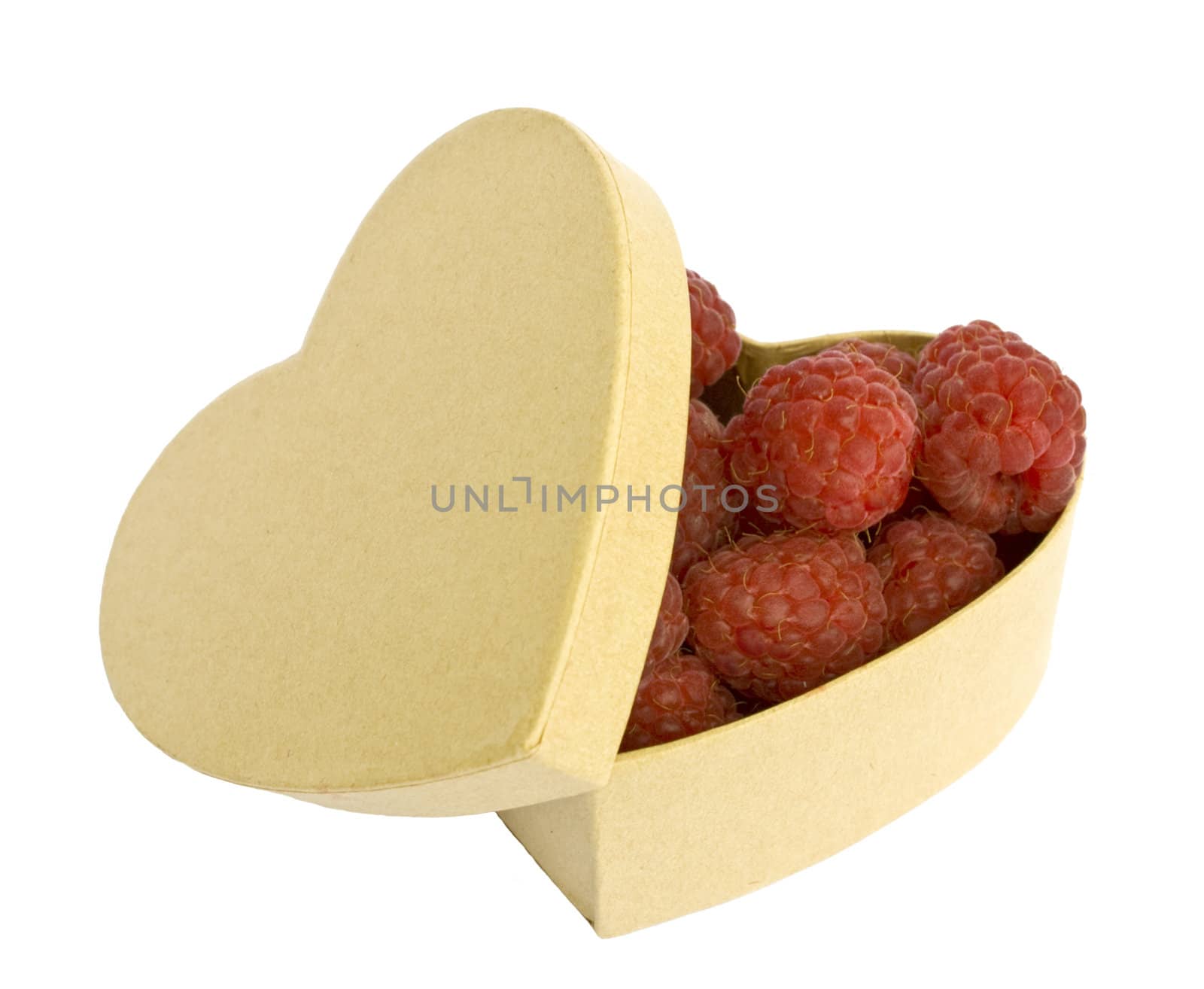 Raspberries in a heart shaped box, isolated on white background.