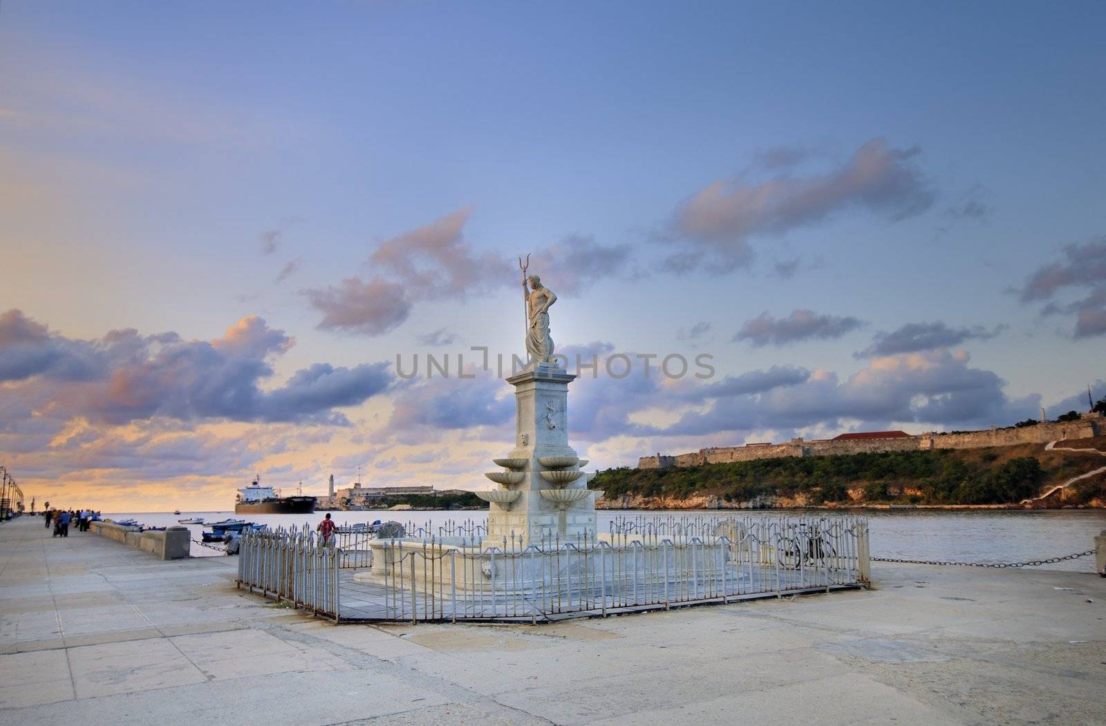Neptune statue in havana bay entrance against sunset sky