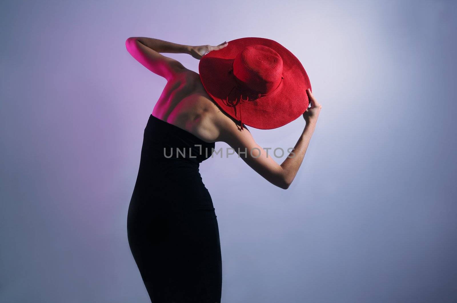 Leaning stylish lady wearing dress and hat by rgbspace