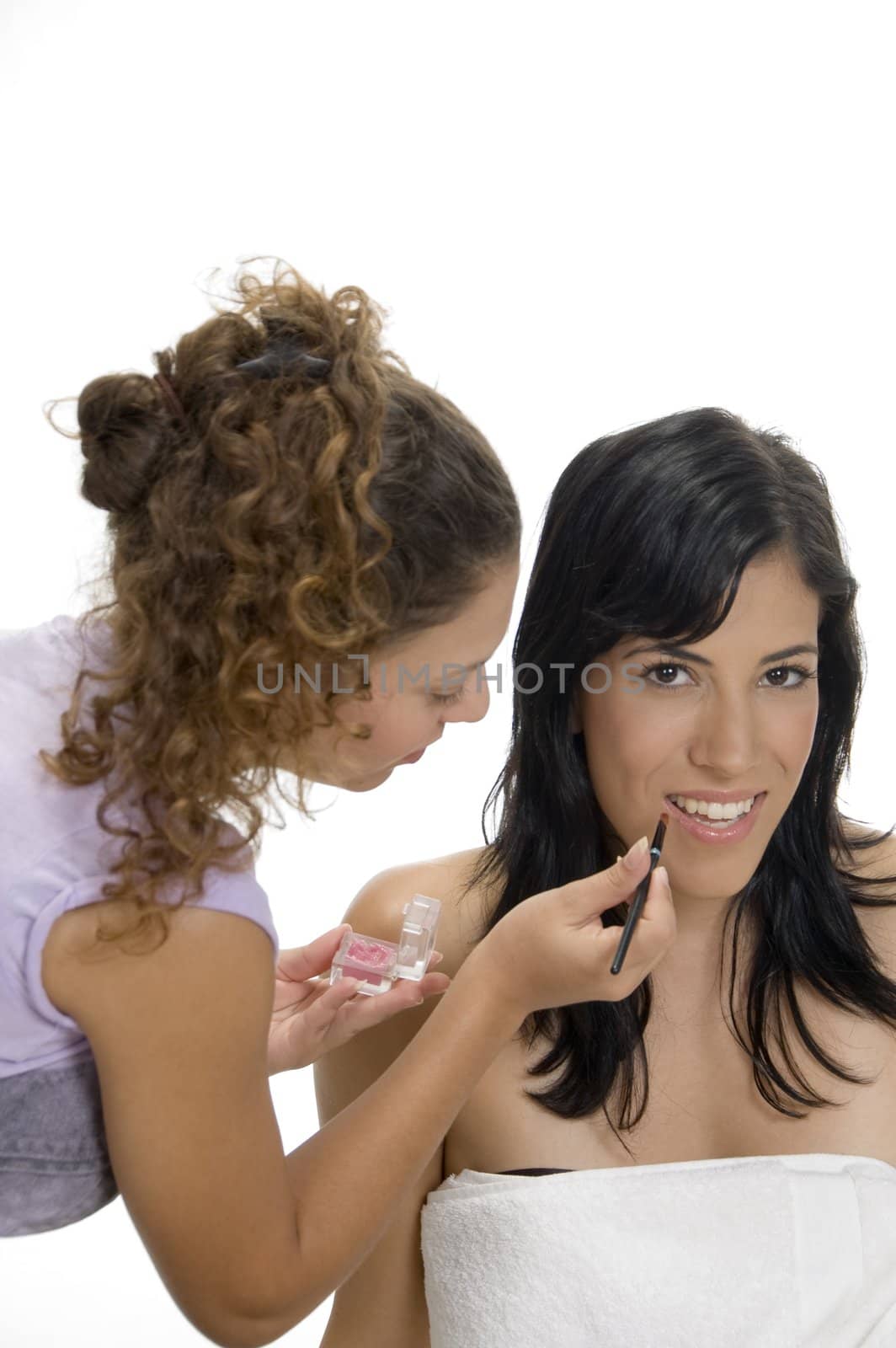 beautician doing makeup on female face by imagerymajestic