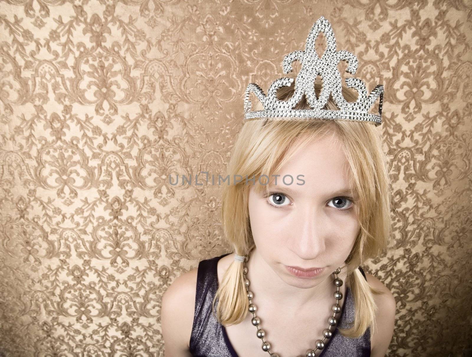 Portrait of pretty pouting young girl wearing a tiara