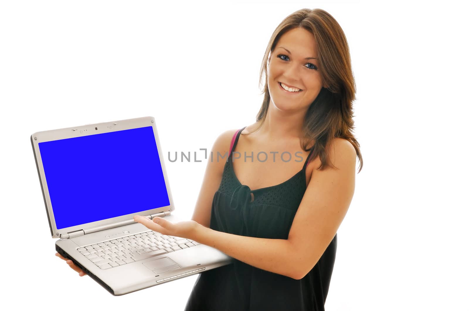 Smiling female brunette pointing at computer isolated.  