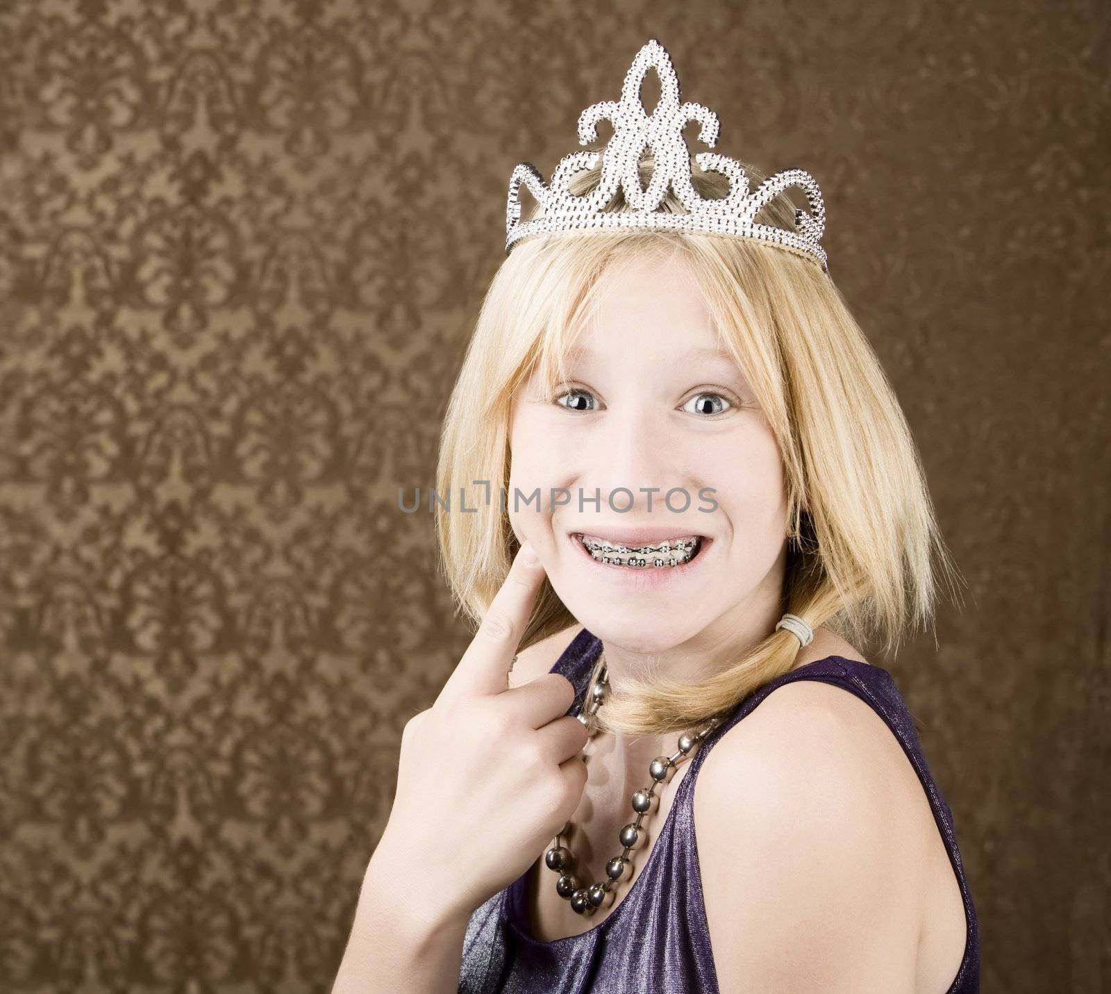 Portrait of pretty young girl with braces wearing a tiara