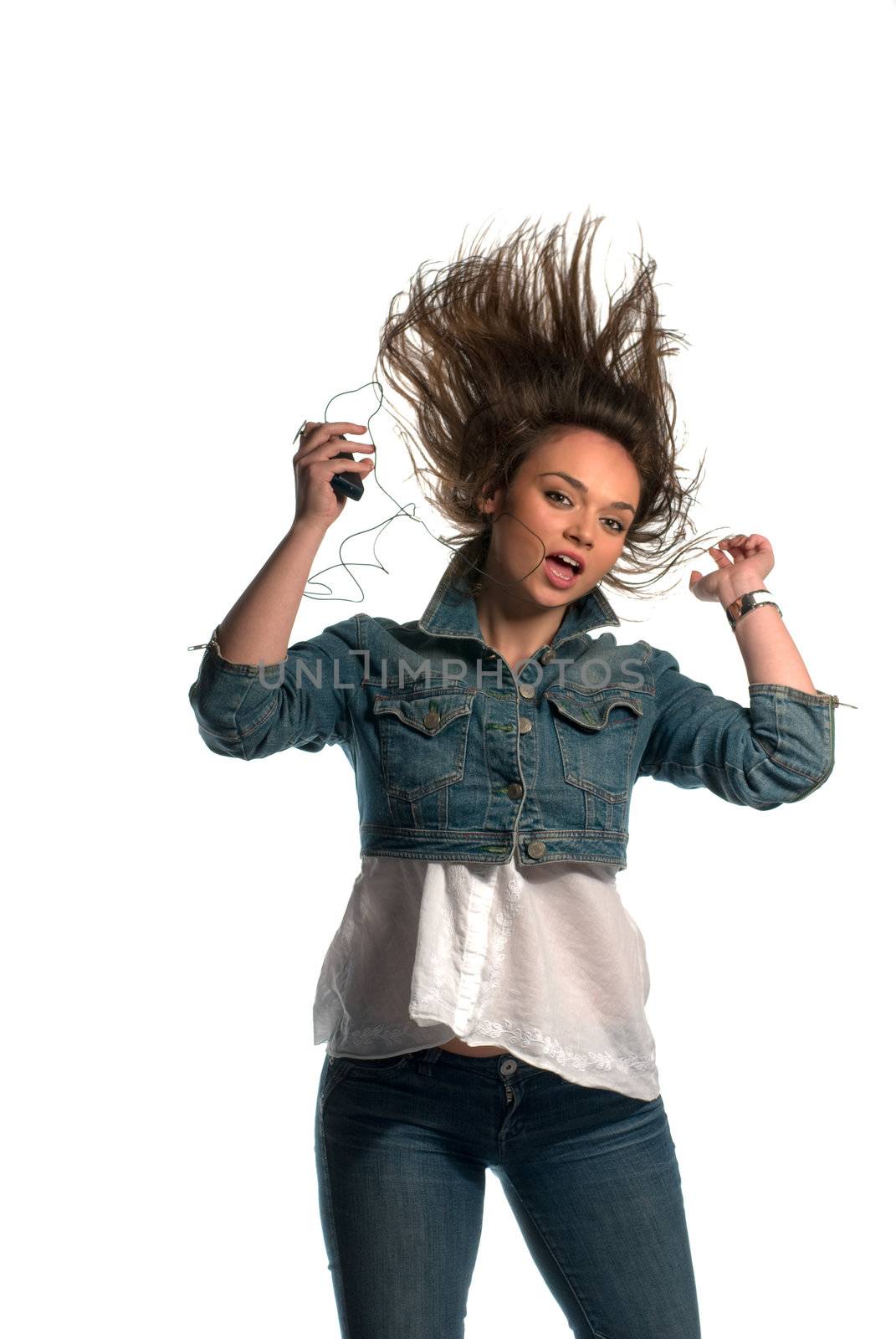 Young woman listening to music and dancing isolated on white