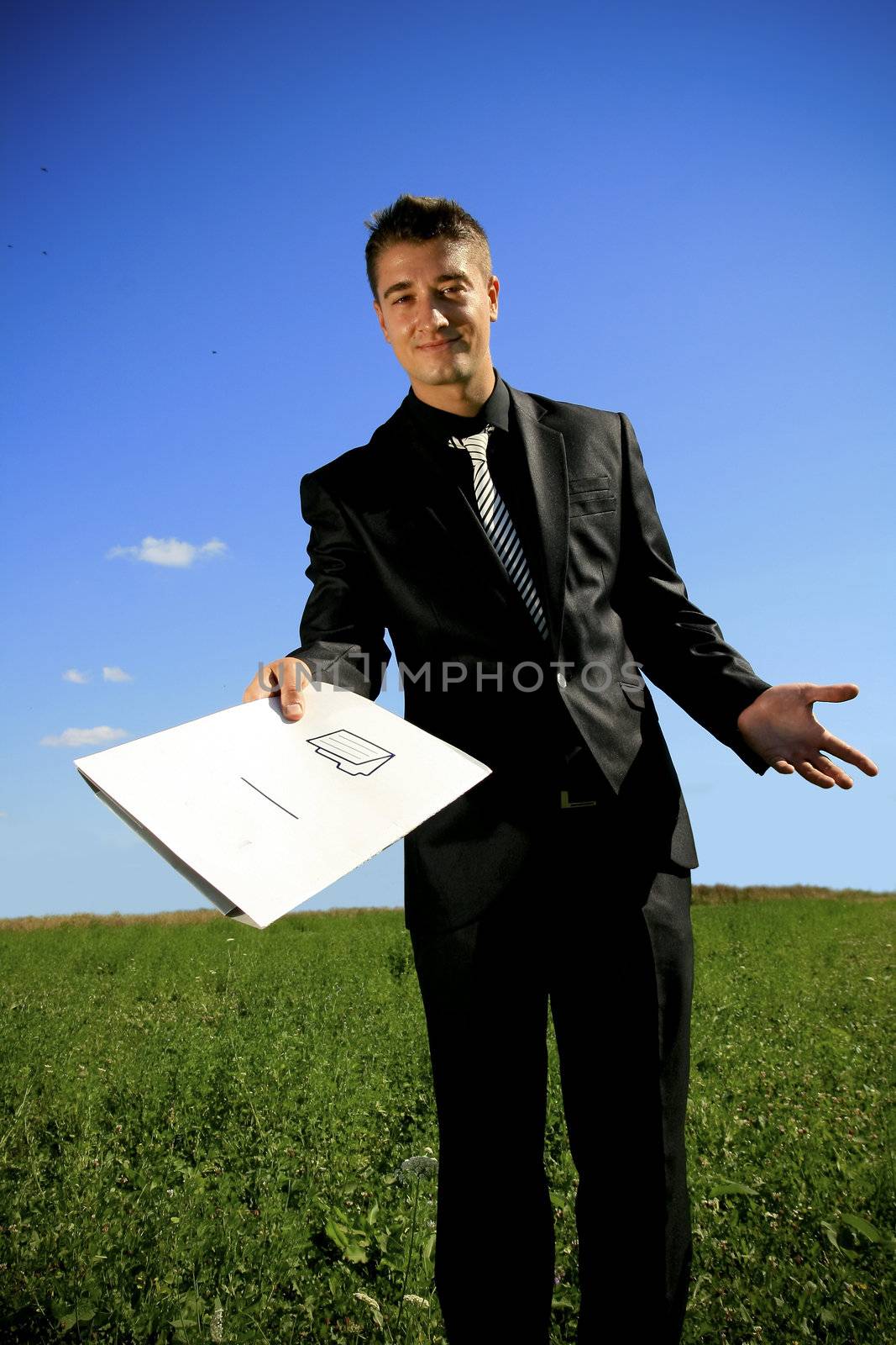 A folder presented to you by a business person in black suit.