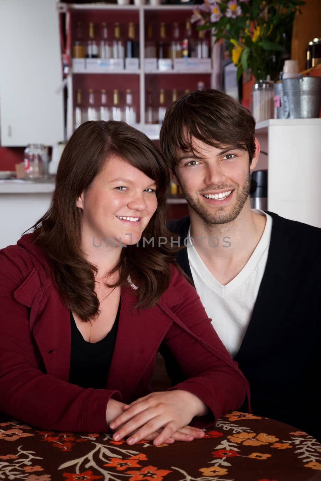 Smiling couple sitting together in a cafe