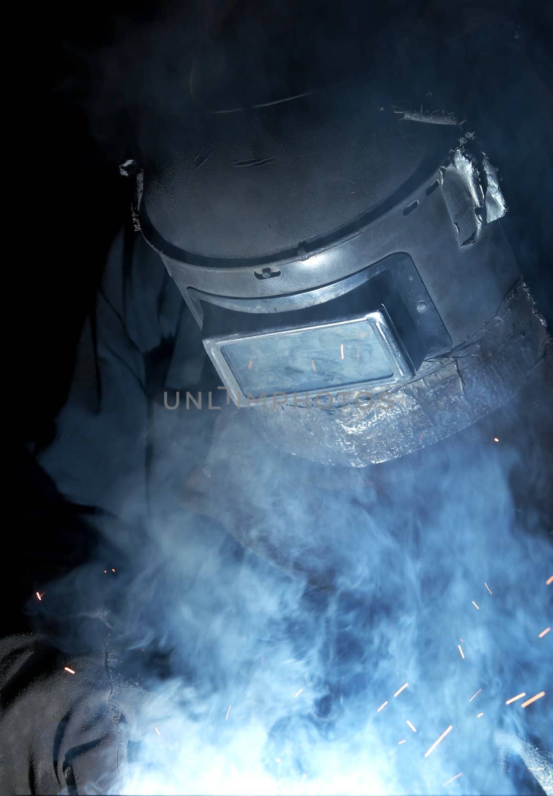 a welder working at shipyard at night