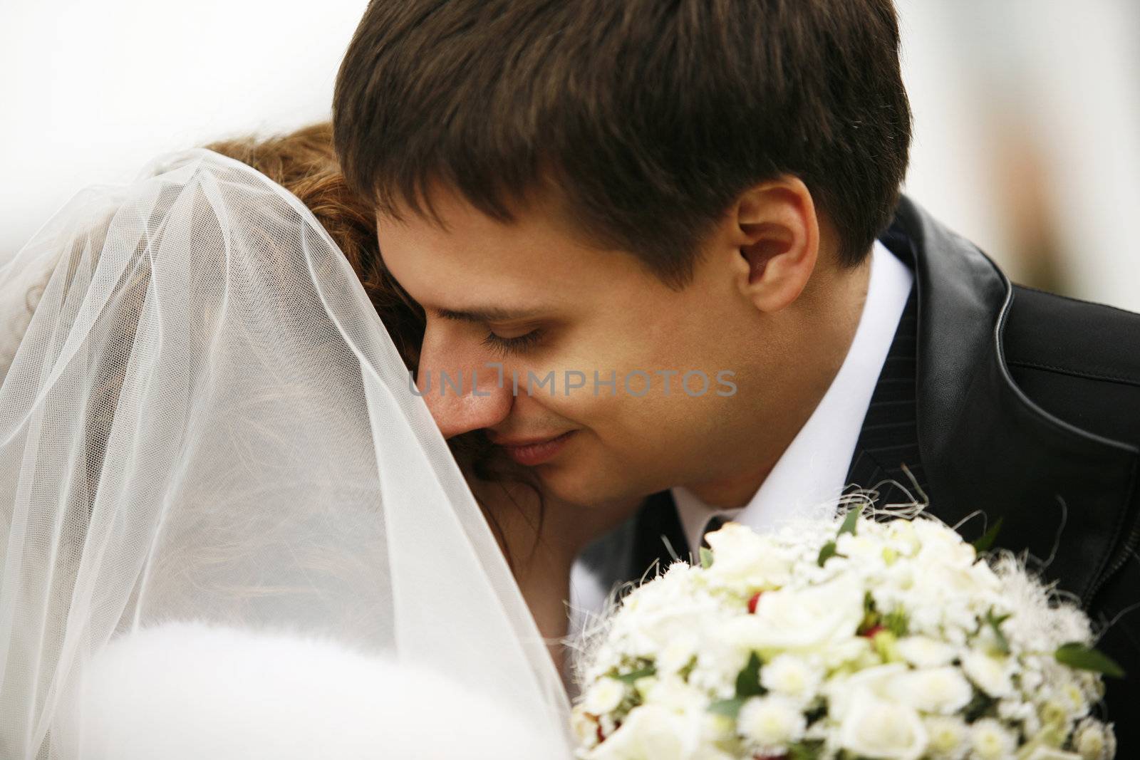 The groom kisses the bride