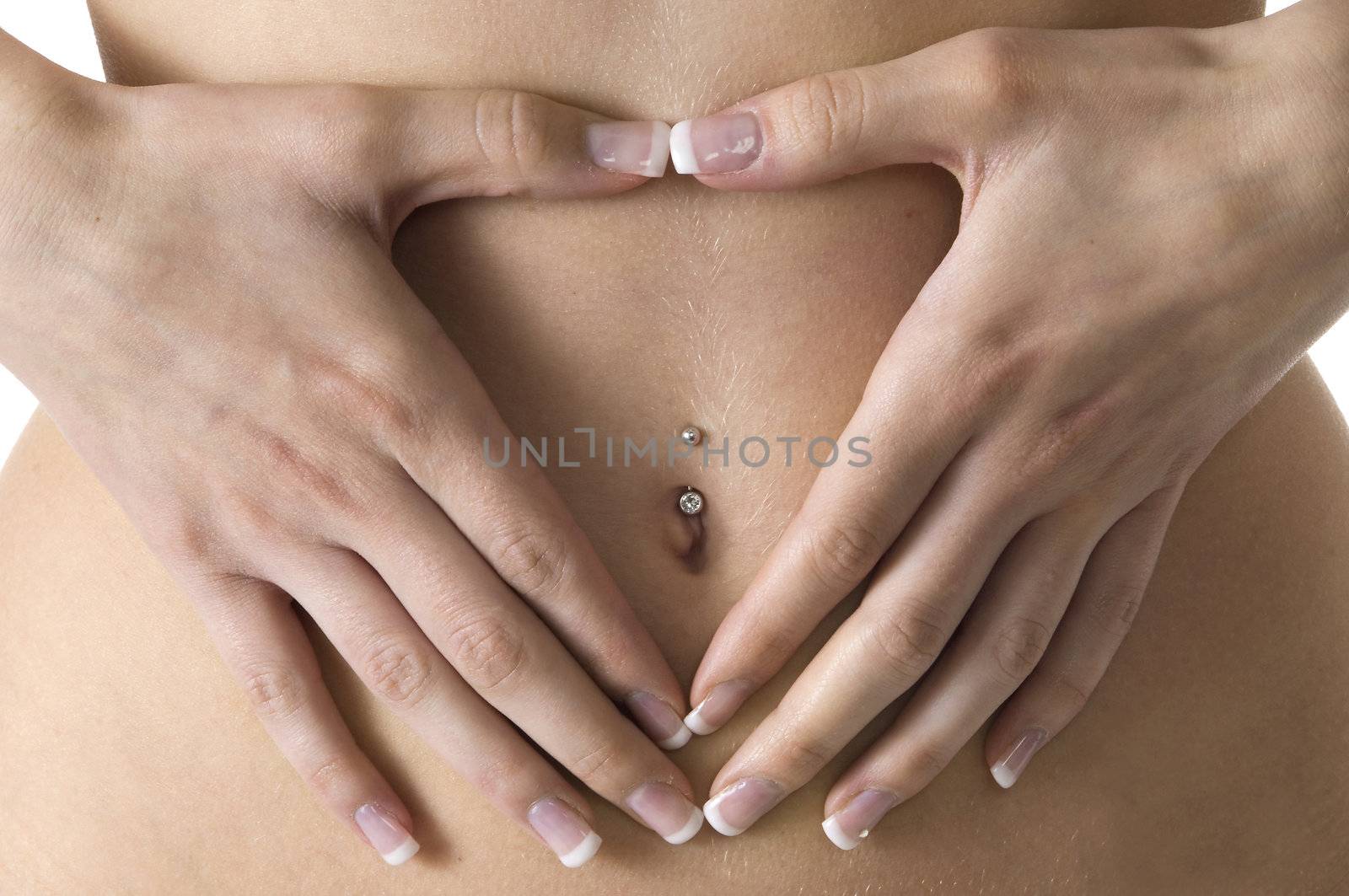 close up of a young female drawing an heart with hands on her stomach