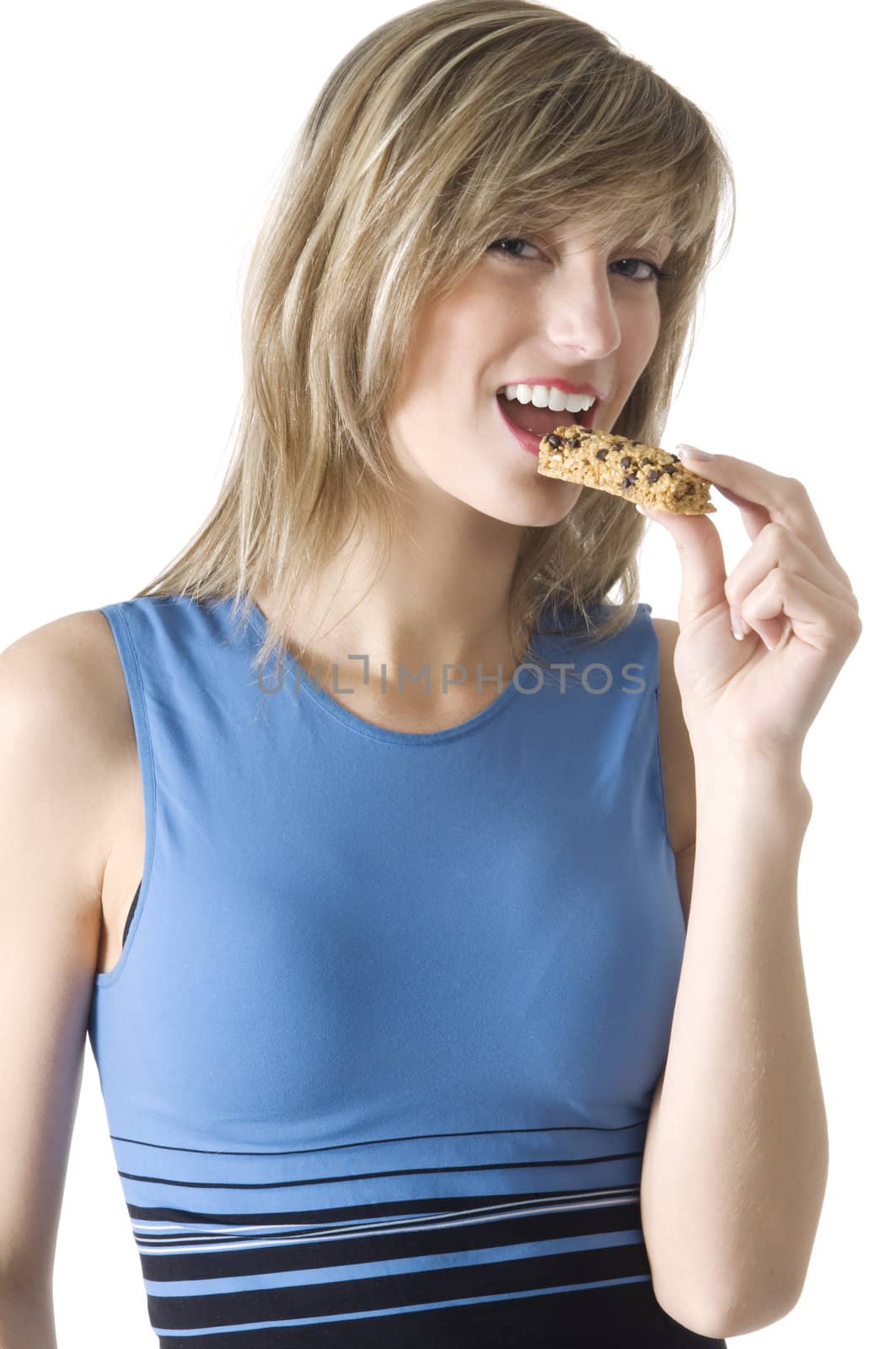 blond girl in blue chemise eating a diet tablet and smiling