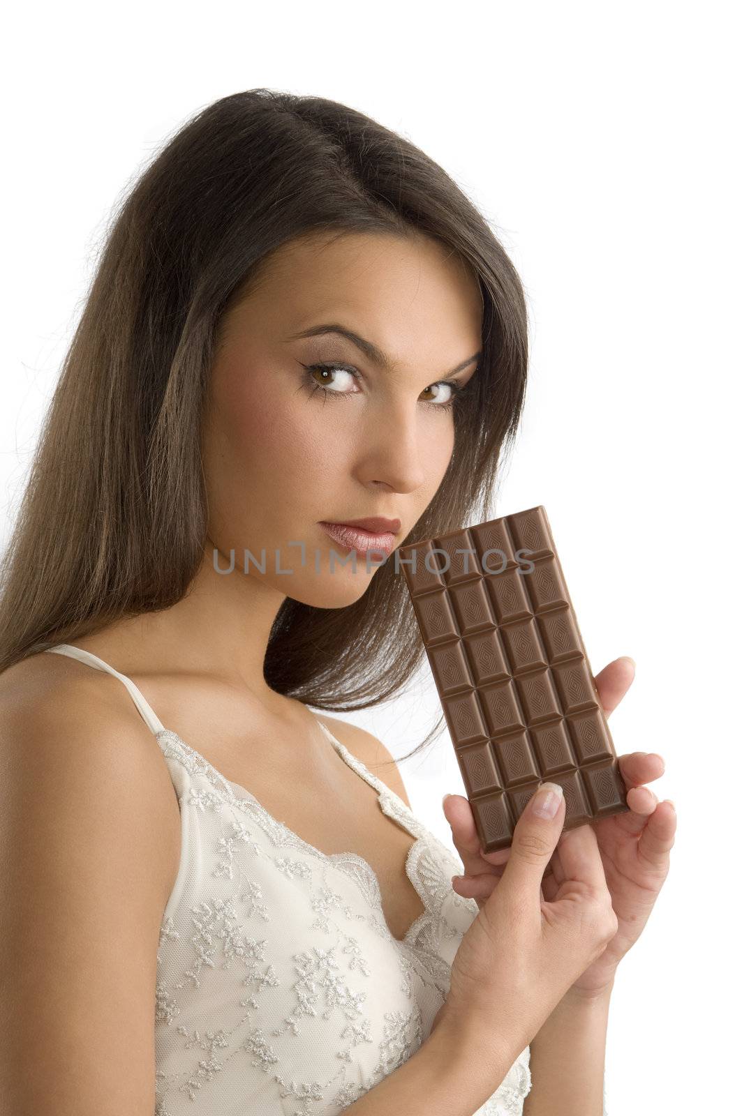 cute brunette with a block of chocolate in her hands looking in camera