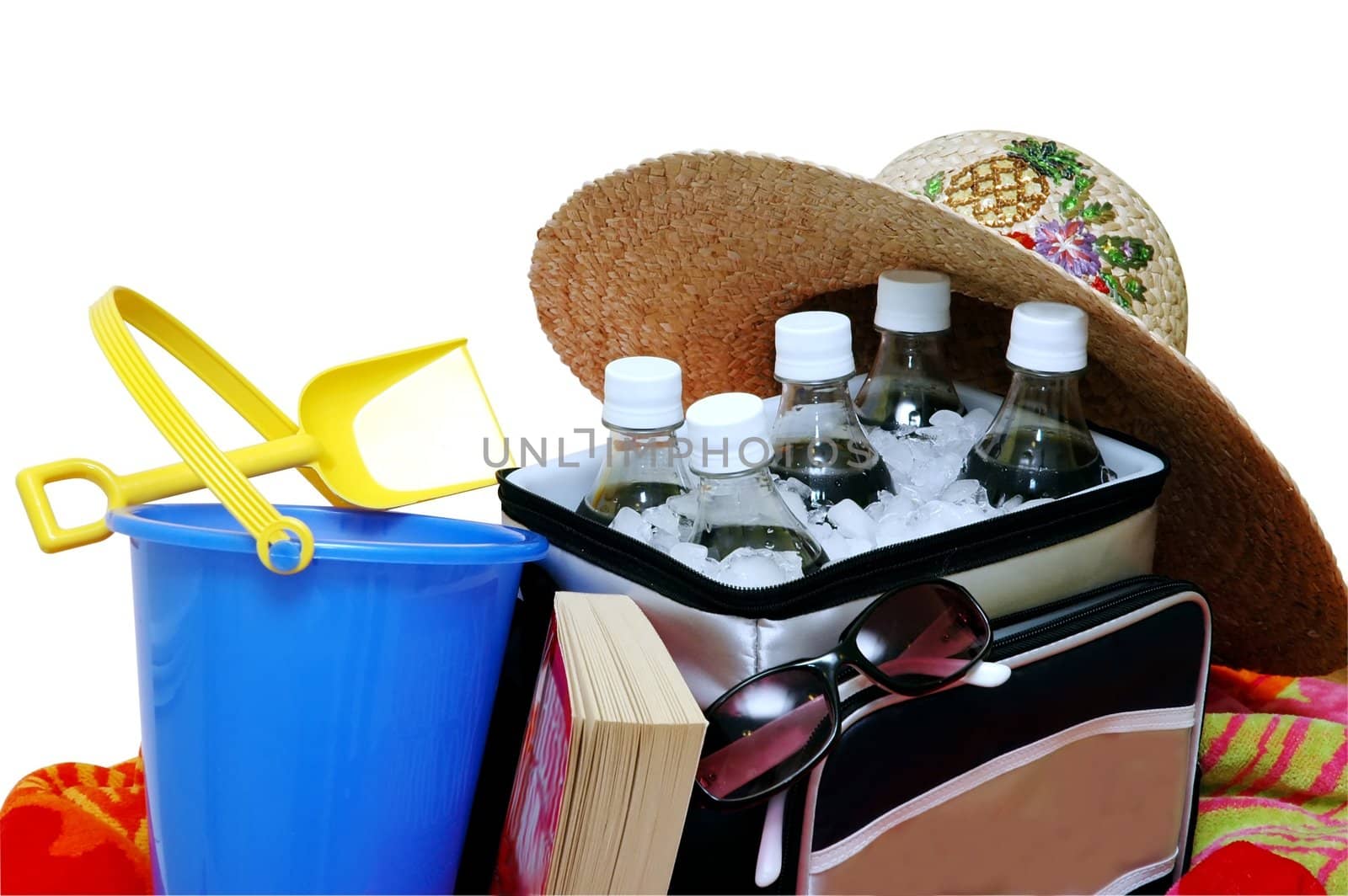 Beach items.  Sun hat, cooler, drinks,sunglasses, book, and sand pail with shovel. Isolated with clipping path.