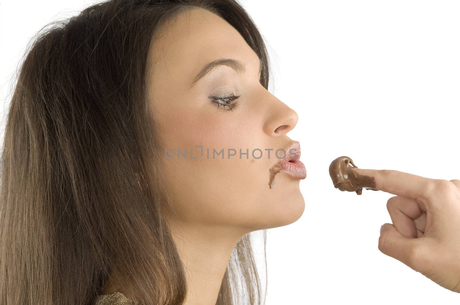 pretty brunette giving a kiss to some some chocolate cream on her finger