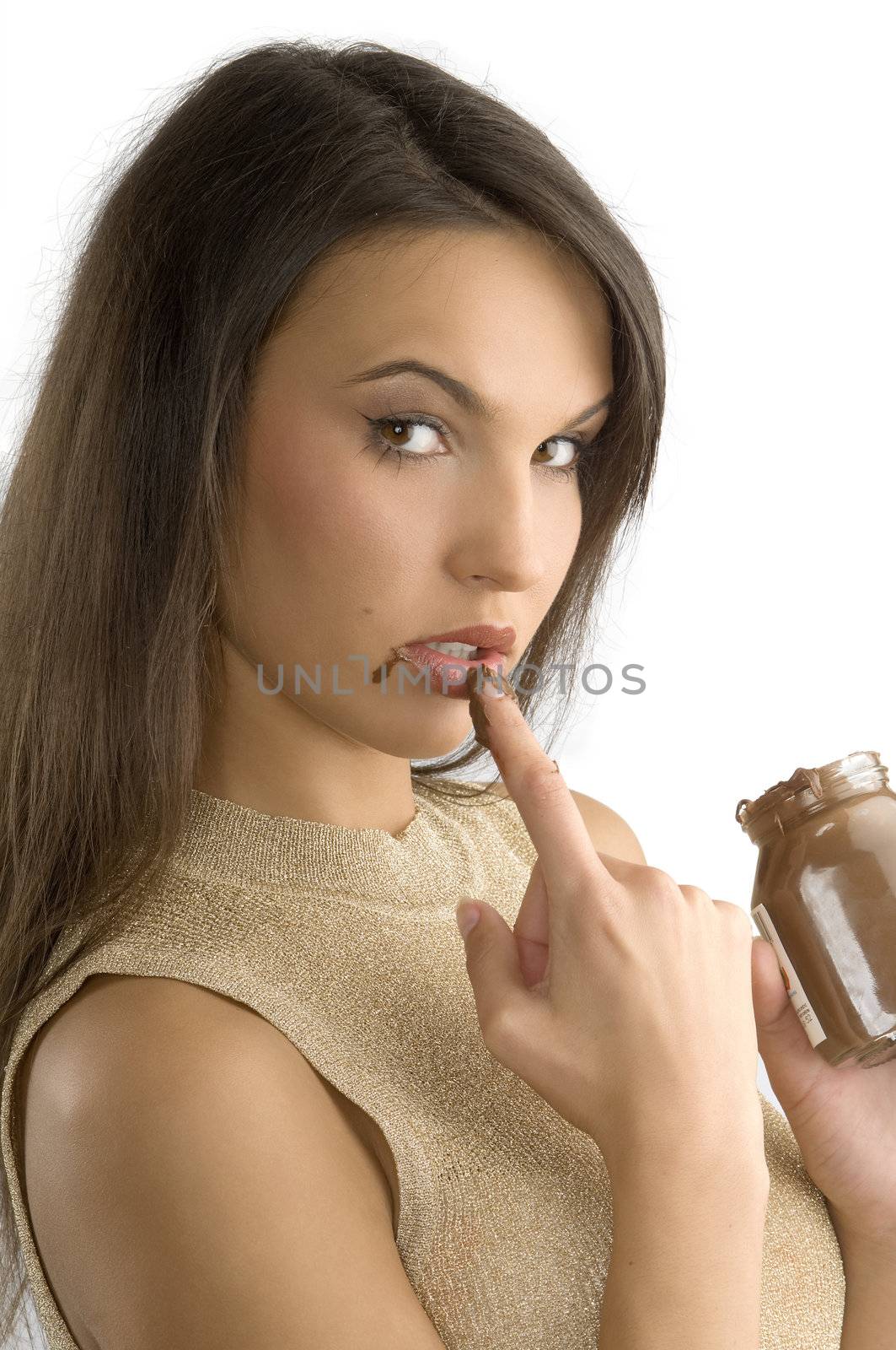 nice girl with long hair eating some chocolate cream from her finger