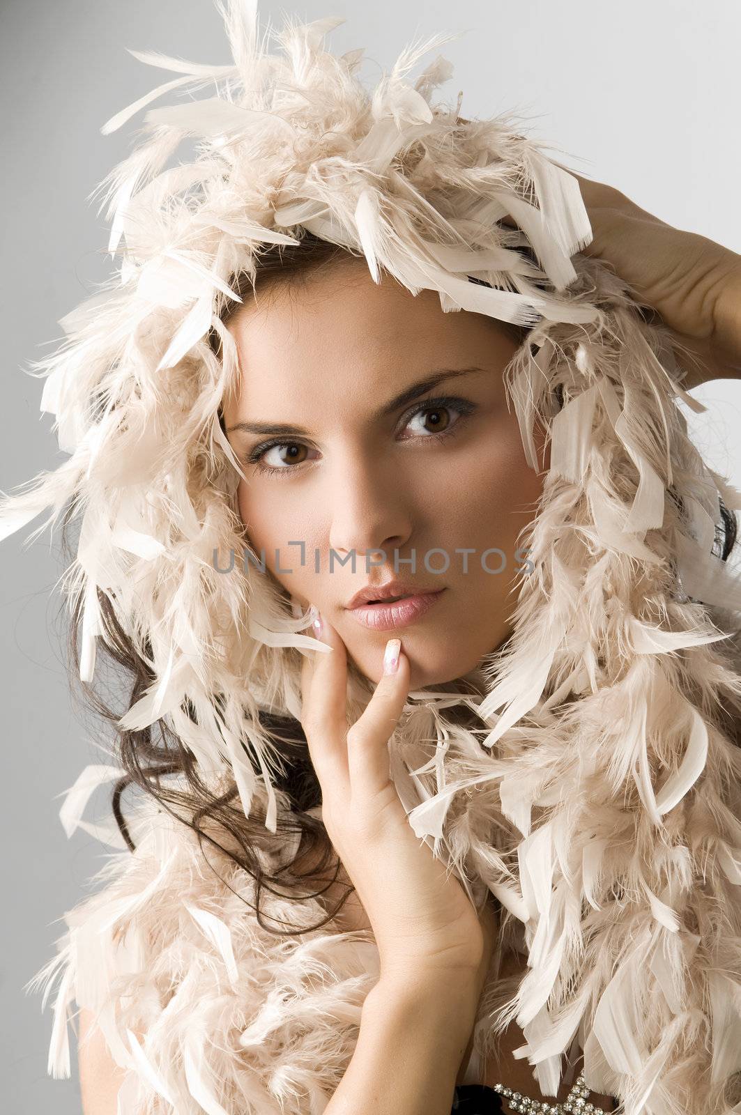 close up of a nice young woman with a boa of feather around her face
