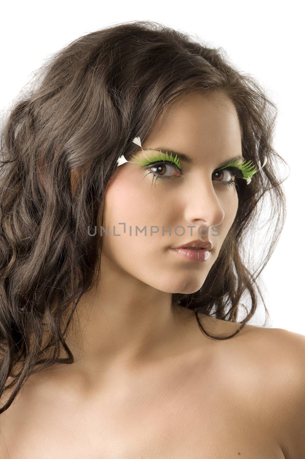 portrait of a young and cute woman with artificial green eyelashes
