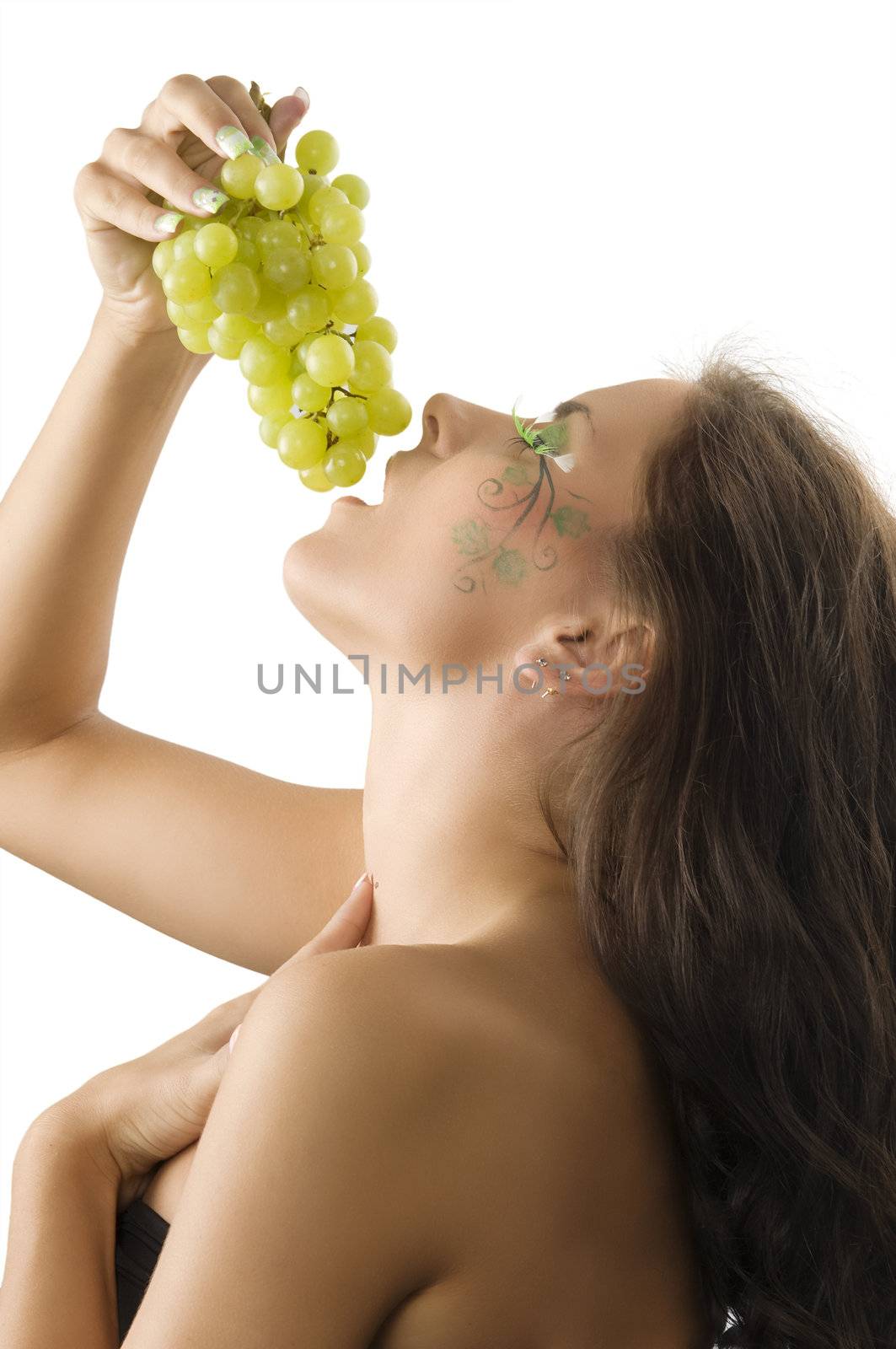 girl eating grape with a nice body paint with leaf on her face