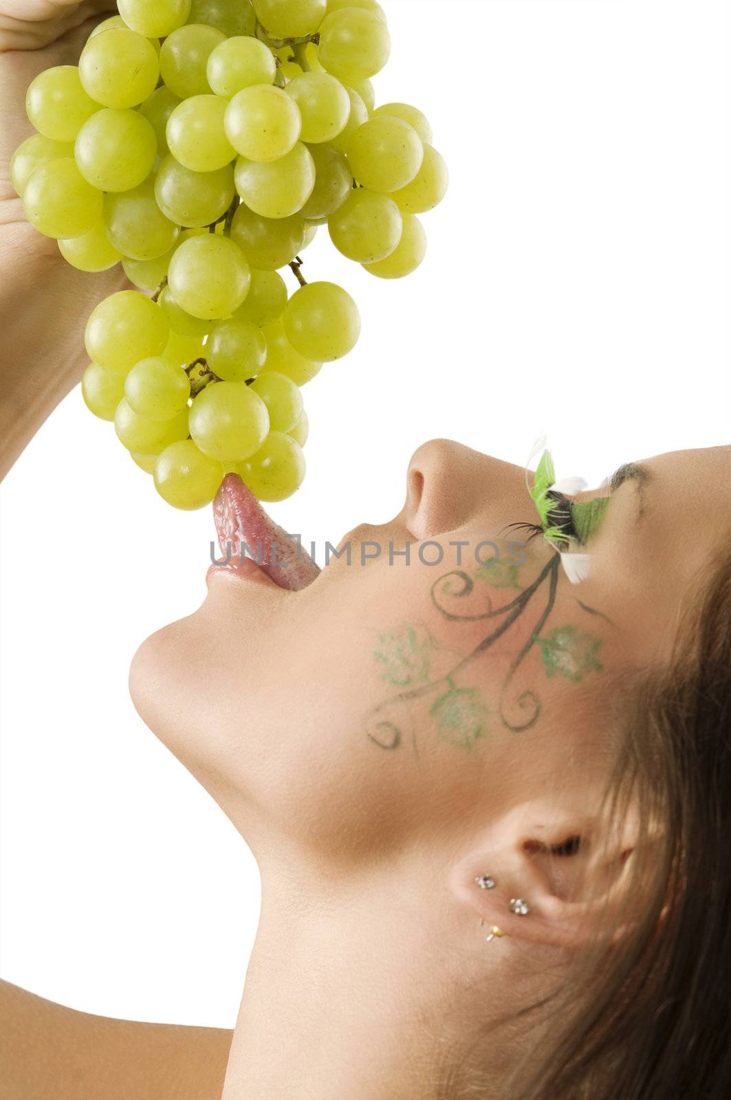 sexy brunette with a nice draw on her face licking green grape