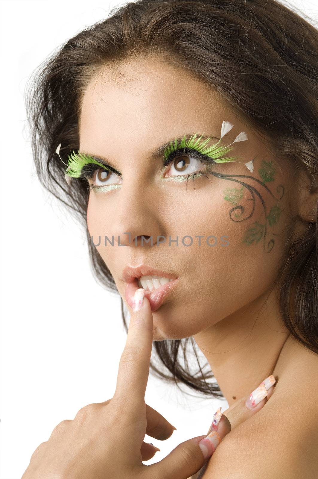 cute and sensual brunette with a finger against the lip and green artificial eyelashes