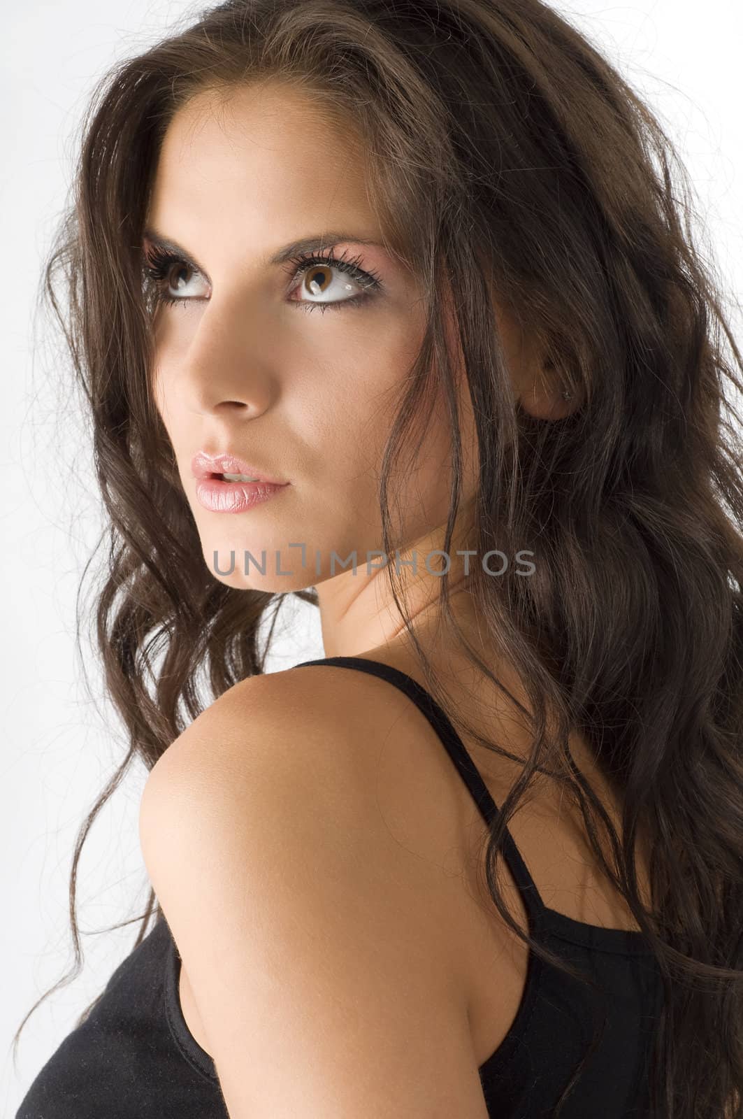 close up of a cute and sexy woman with moved hair and sensual eyes