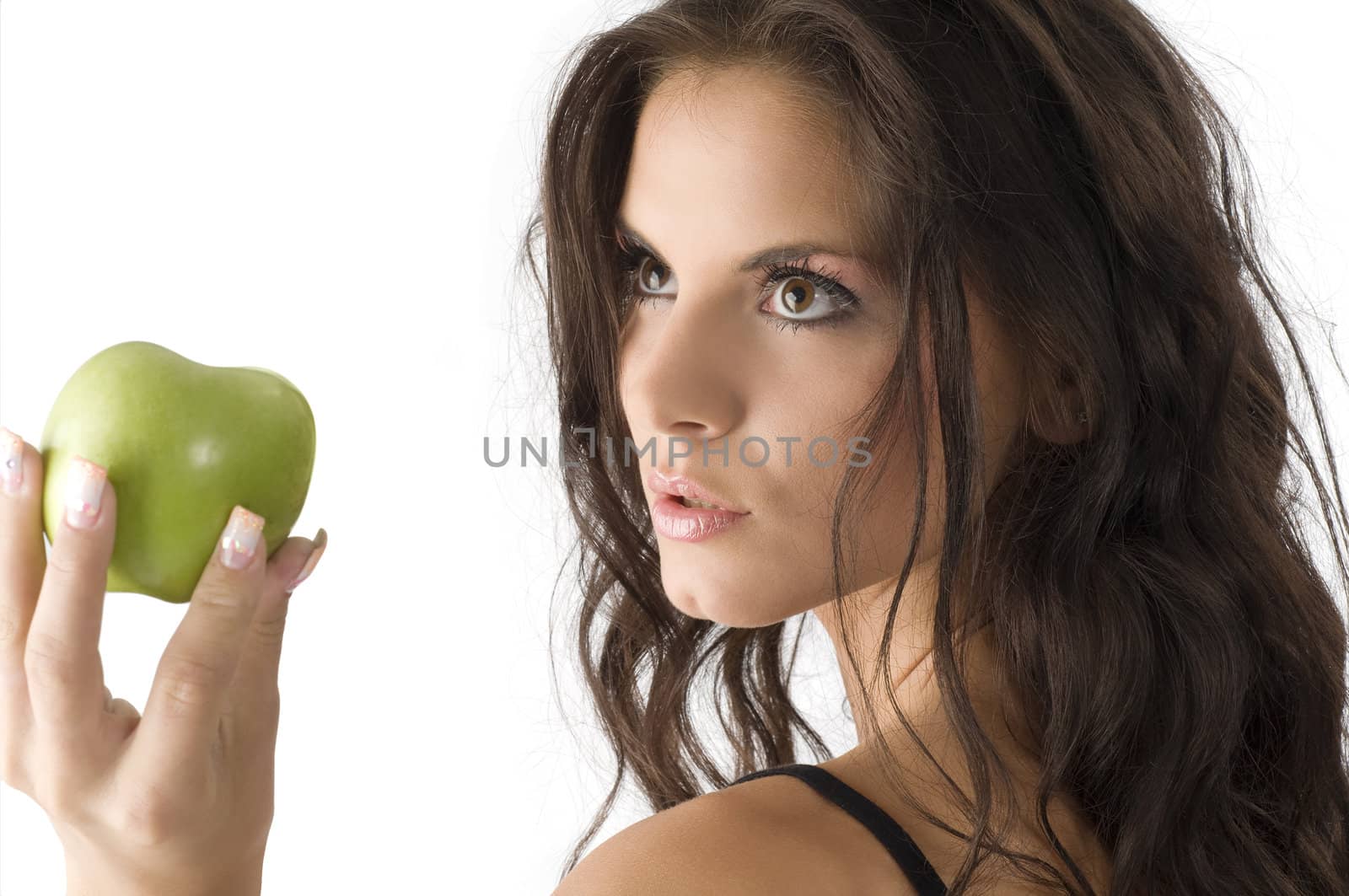 portrait of a sensual brunette looking a green apple
