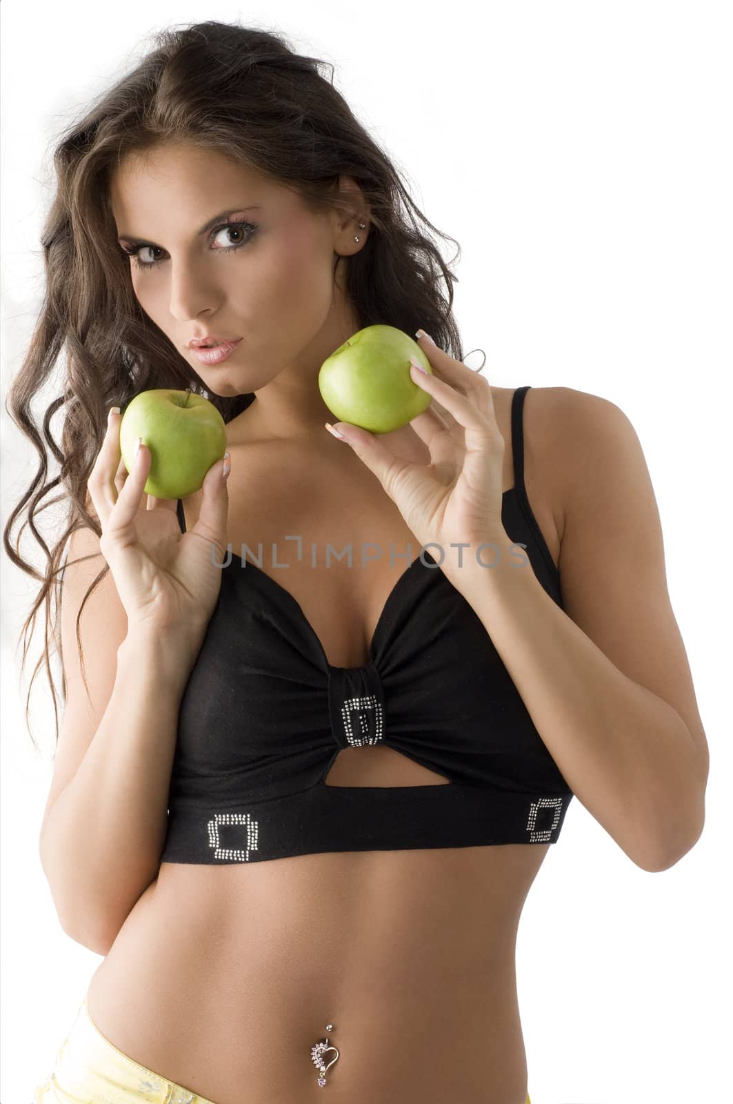 sensual and cute brunette with two green apple looking in camera,