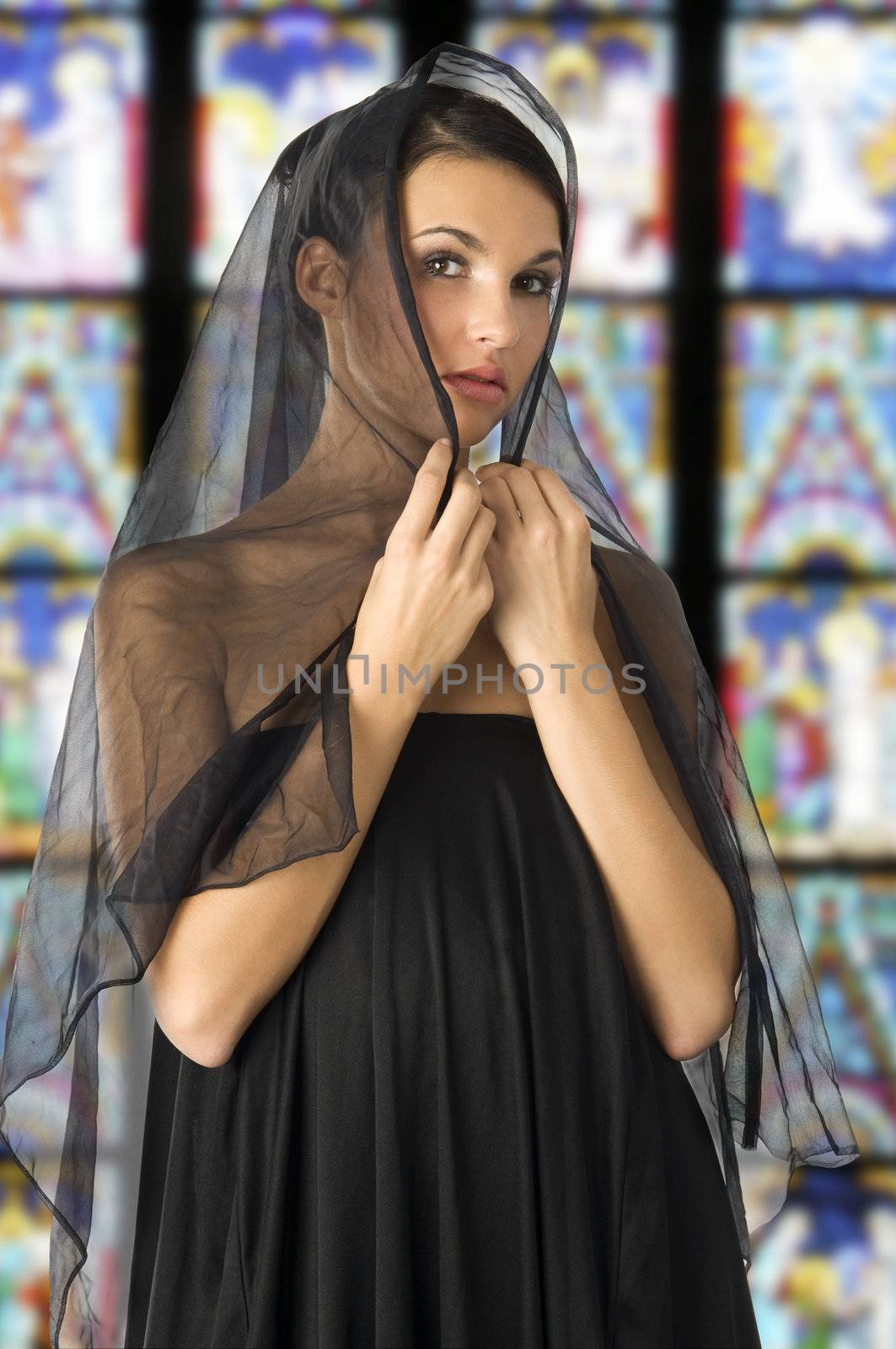 beautiful woman with a black veil on her head like old sicily fashion