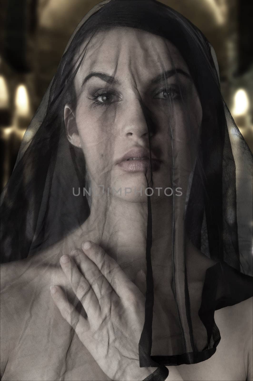 cute woman with a black transparent veil on face like a sicilian widow