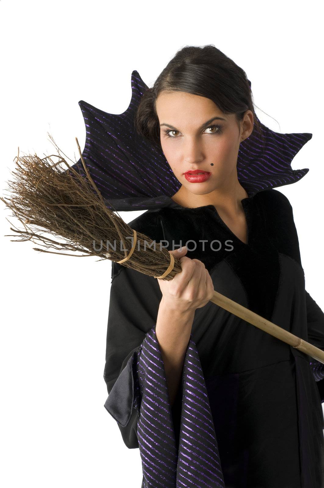 cute witch with a broom in act to fighting against you