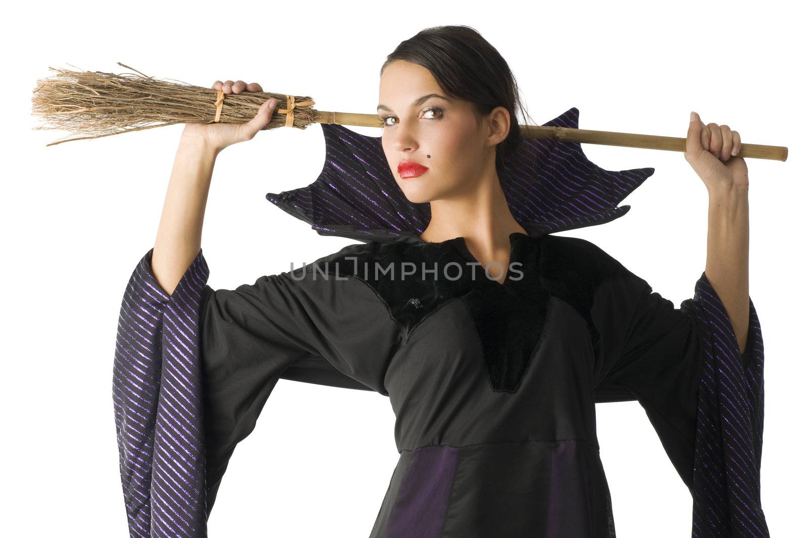 portrait of a young witch with a broom behind her head