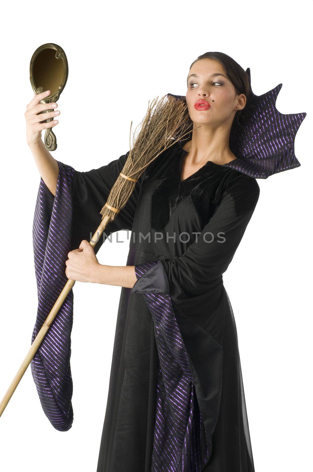 witch playing with a broom as a beauty brush