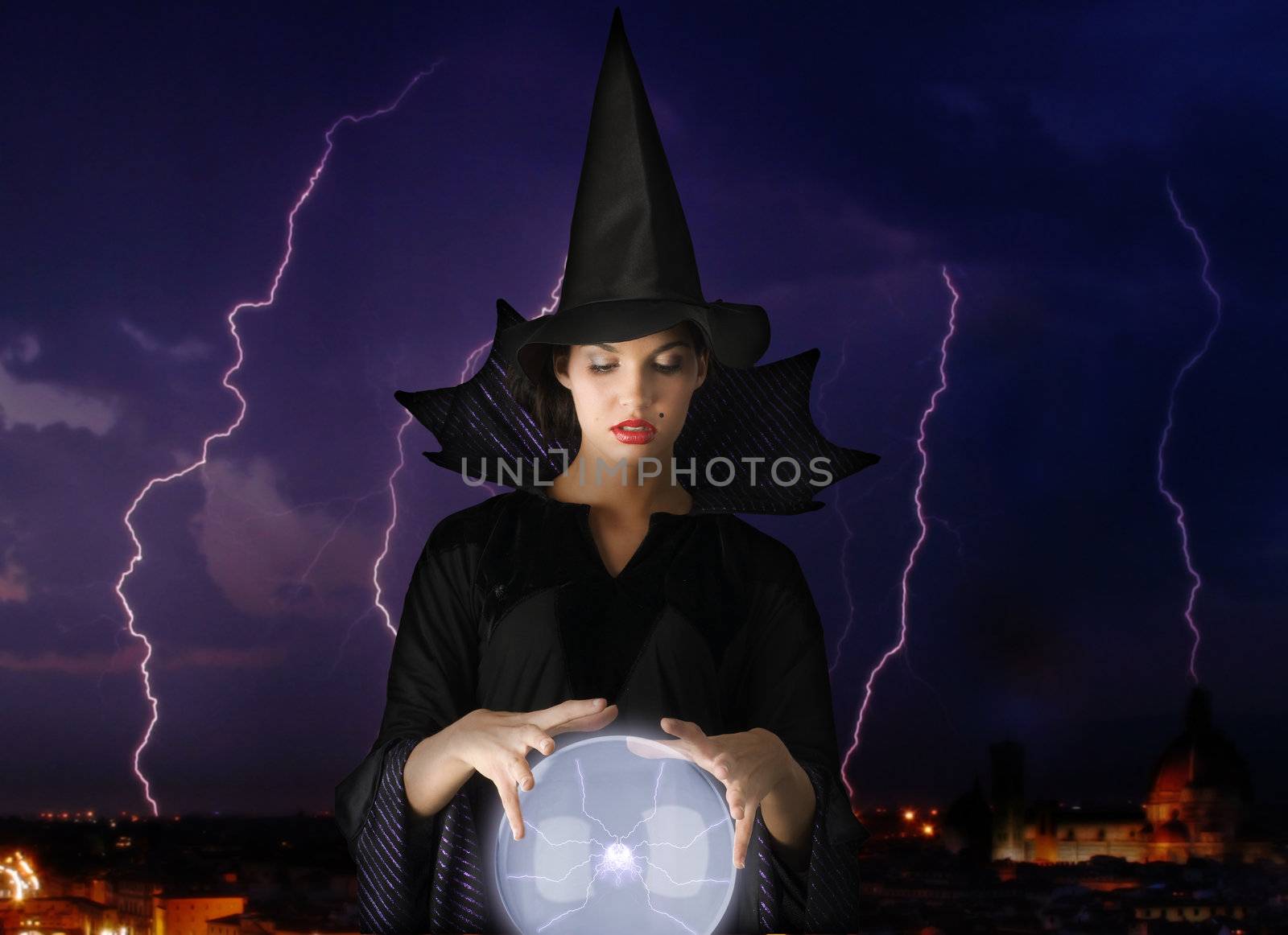 witch with magic crystal ball and lightning in background