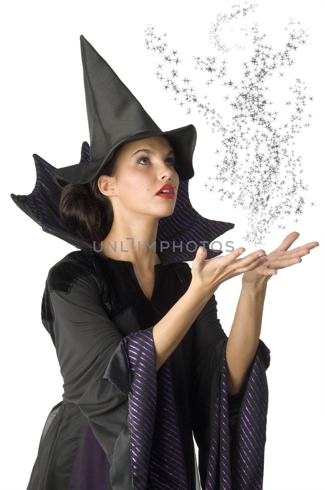 pretty witch with black dress and hat doing a magic spell