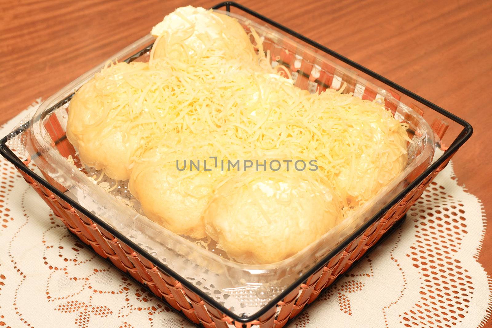 filipino sweet bread topped with lots of cheese and butter
