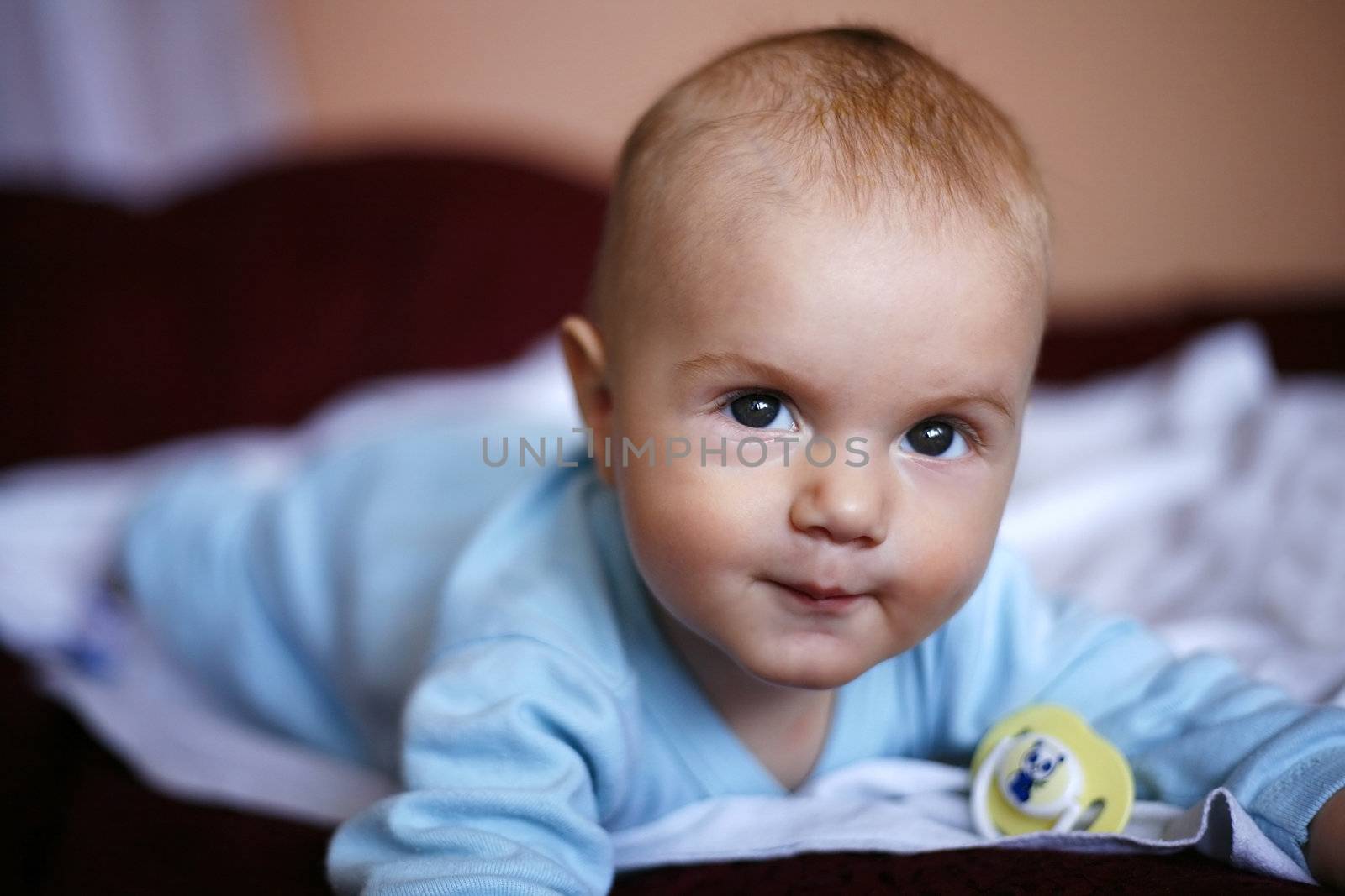 four-monthly new born child in a bed