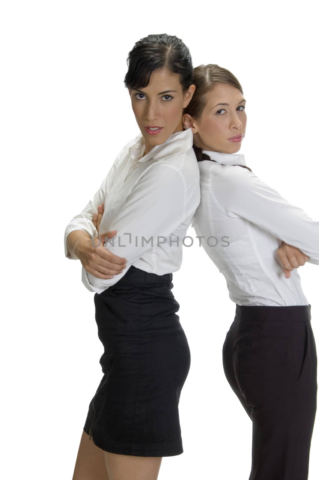 young women standing back to back with white background