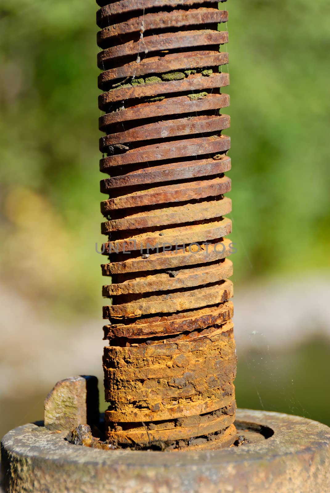 Screw of a flood gate, covered with a layer of rust
