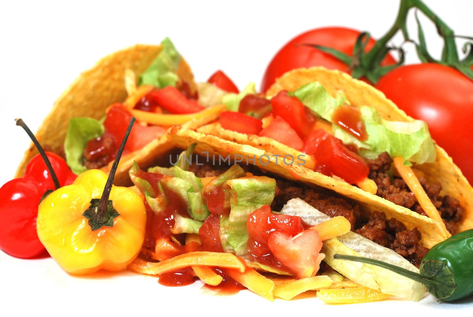 Closeup of tacos with tomatoes, habanero and serano peppers.  Isolated on white background.