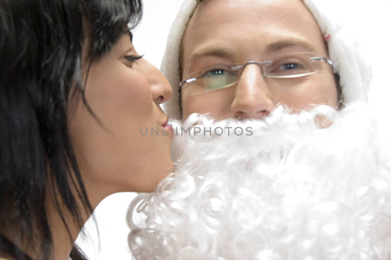 woman kissing to santa man against white background