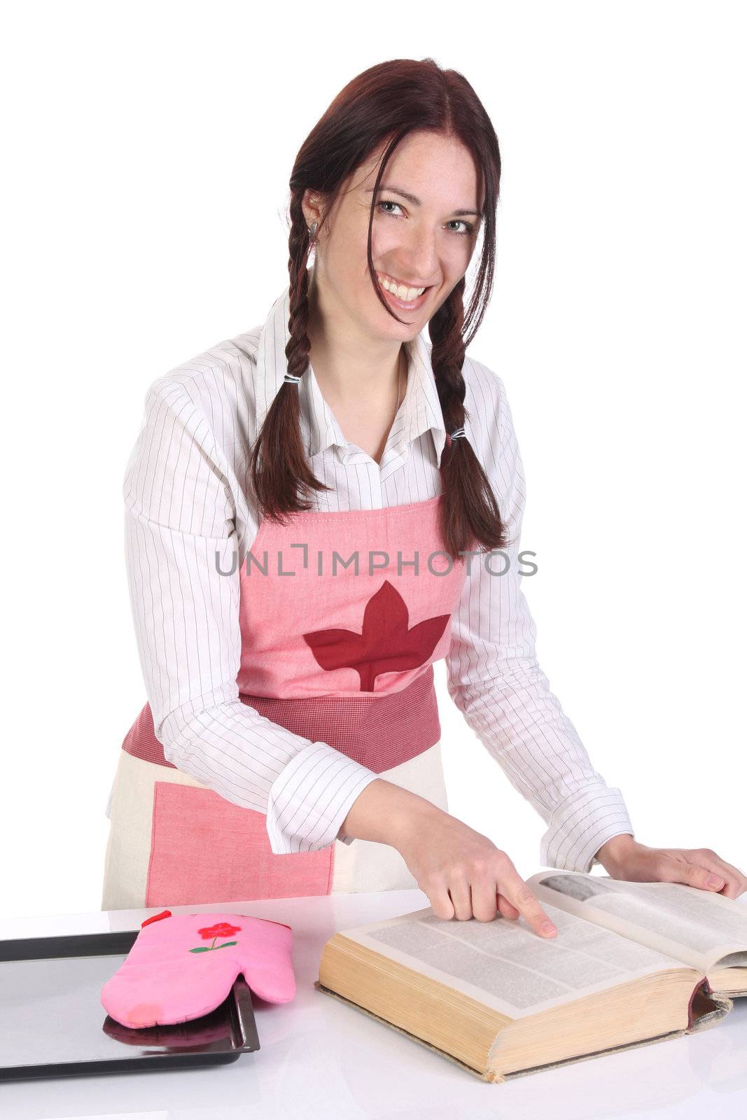 beautiful housewife preparing and reading with a book recipe