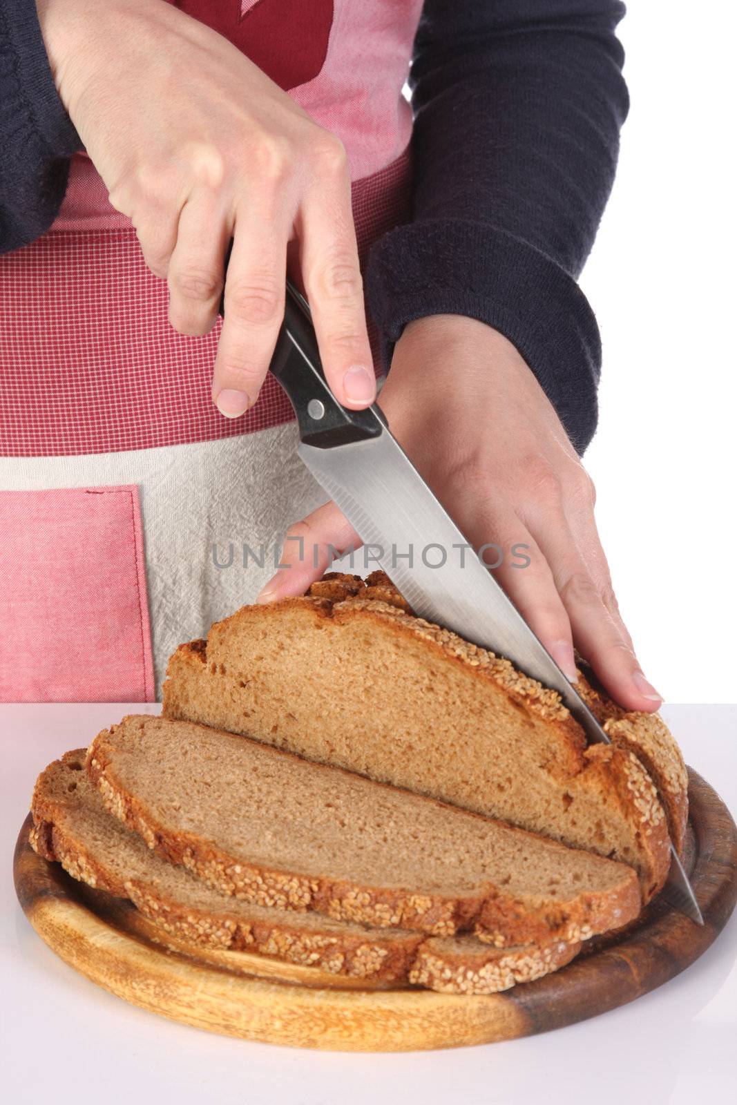 details cutting bread with knife in closeup