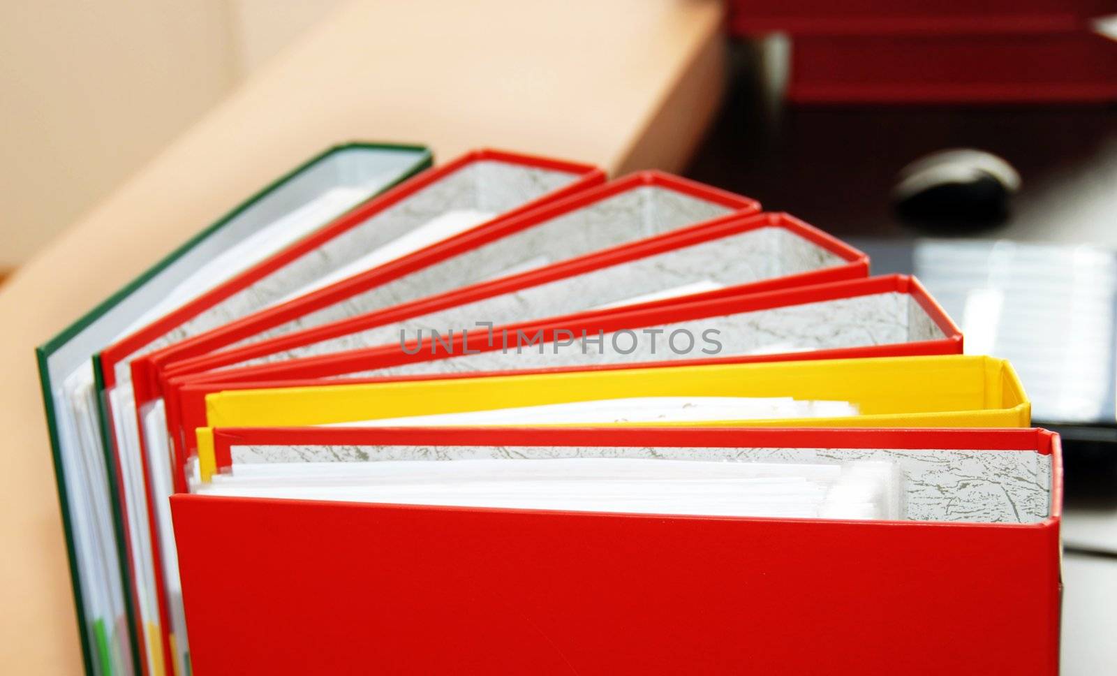 colorful files with documents  on office desk