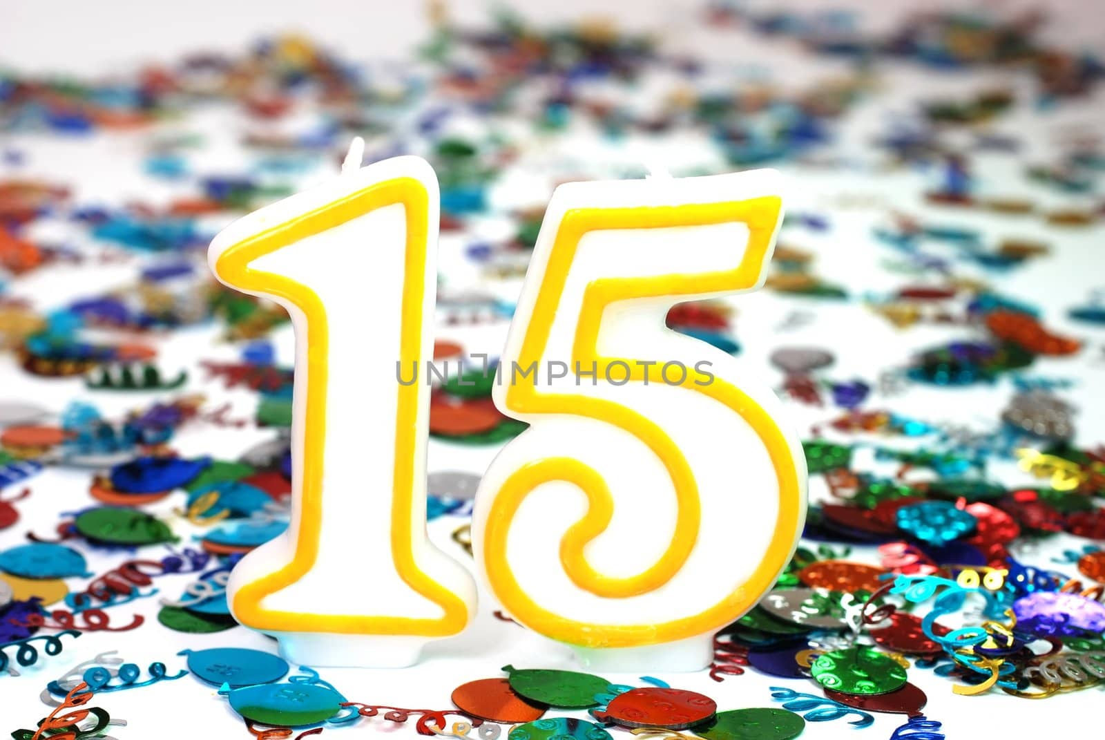 Number 15 celebration candle with confetti.