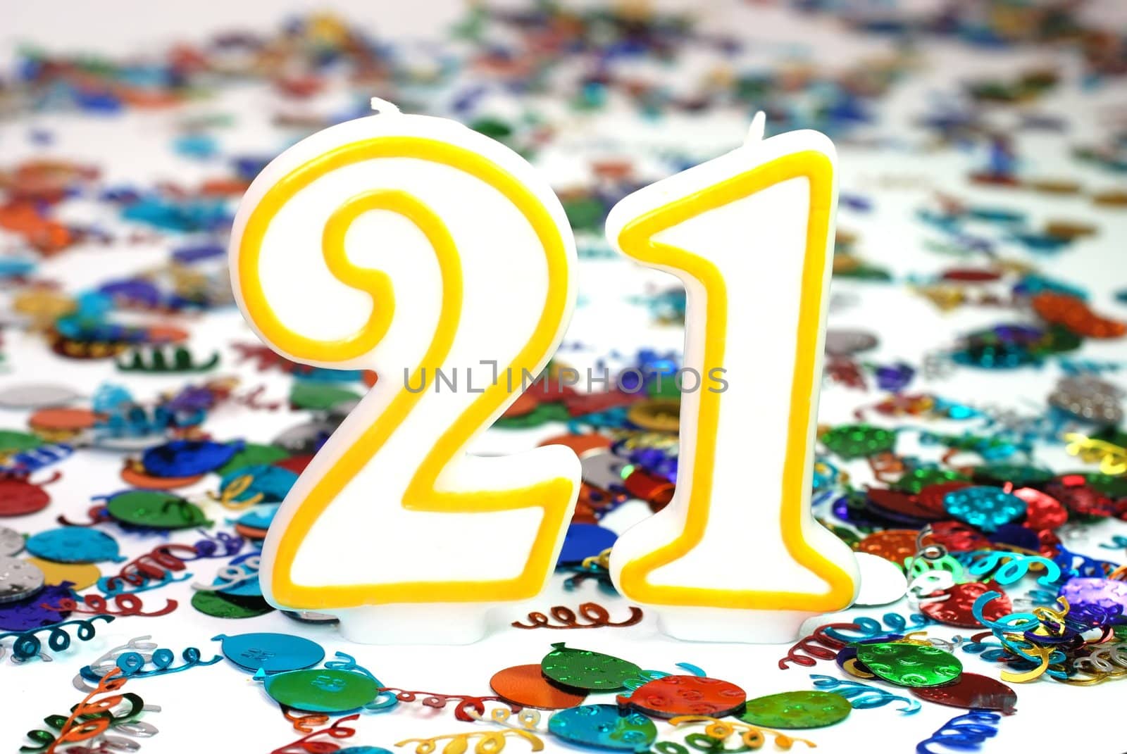 Number 21 celebration candle with confetti.