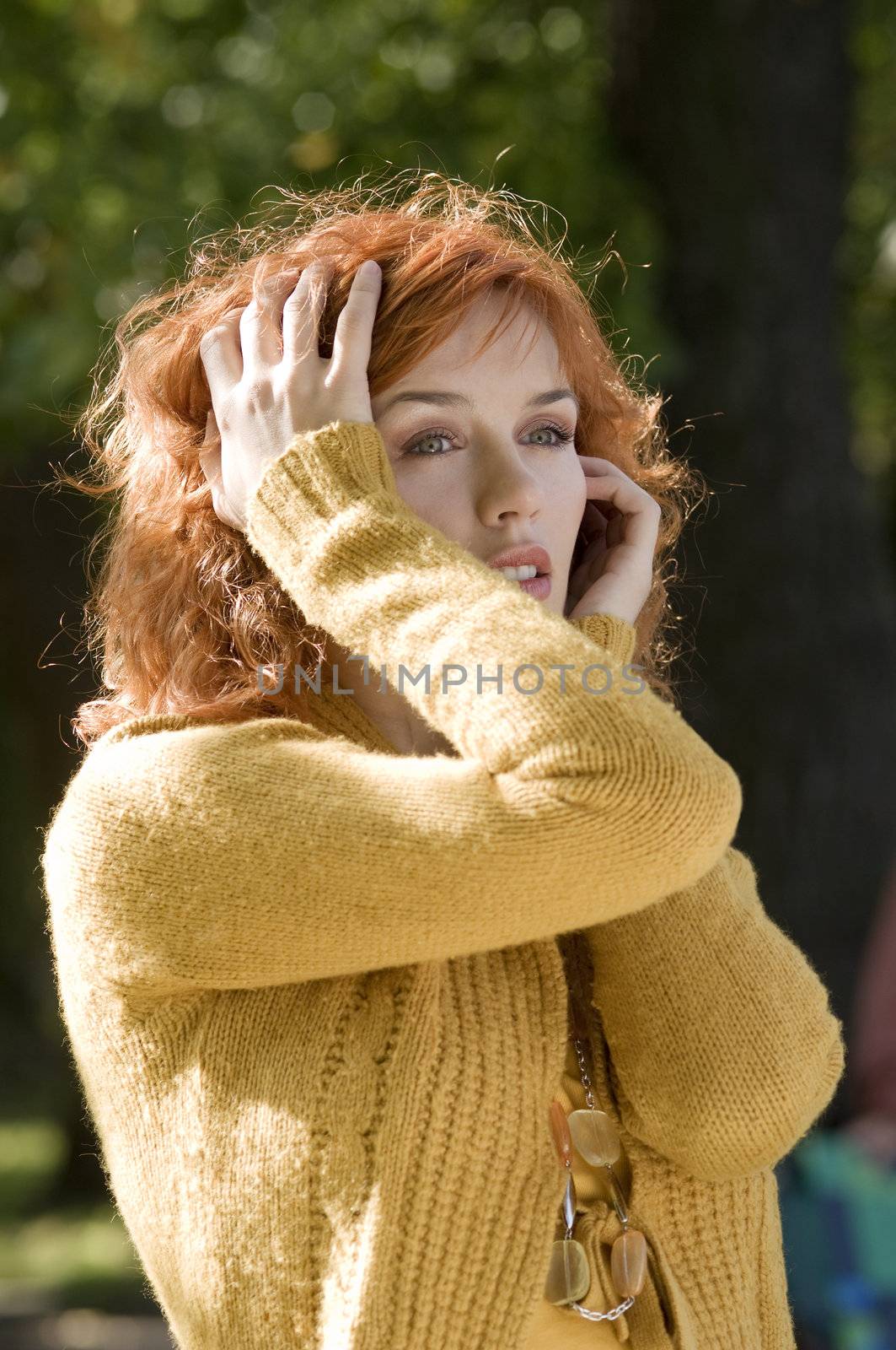 fashion portrait of young red woman in yellow autumn clothes