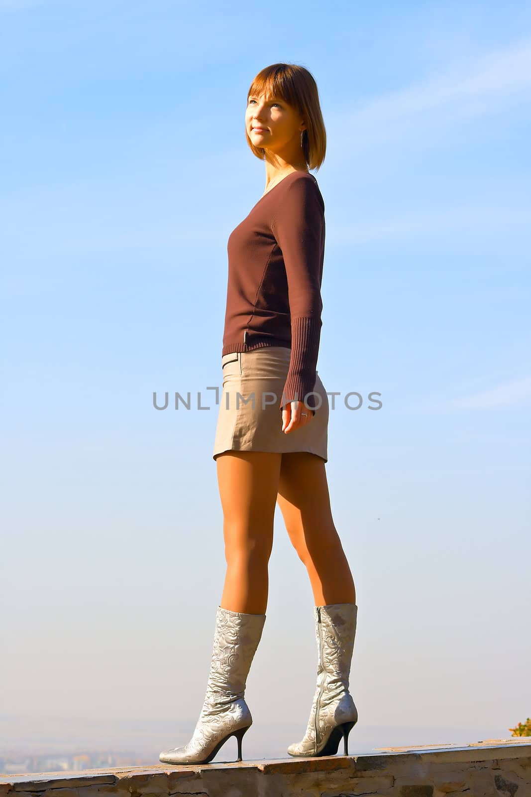 the beautiful young girl against blue sky