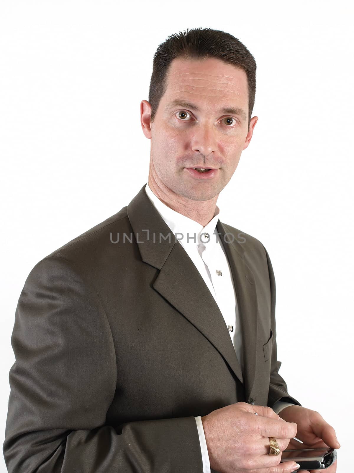 A man in a suit holds a pda in his hand, ready to make a note.