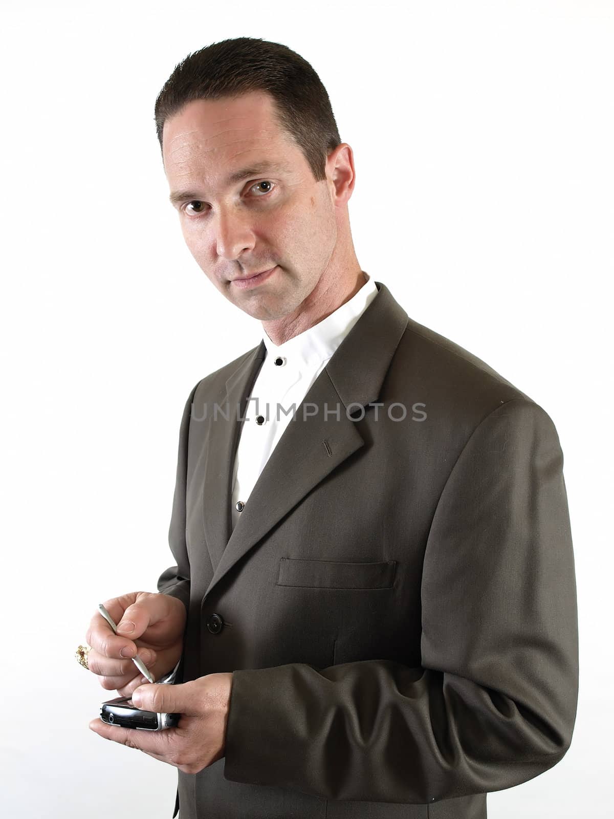 A man in a suit holds a pda in his hand, ready to make a note.