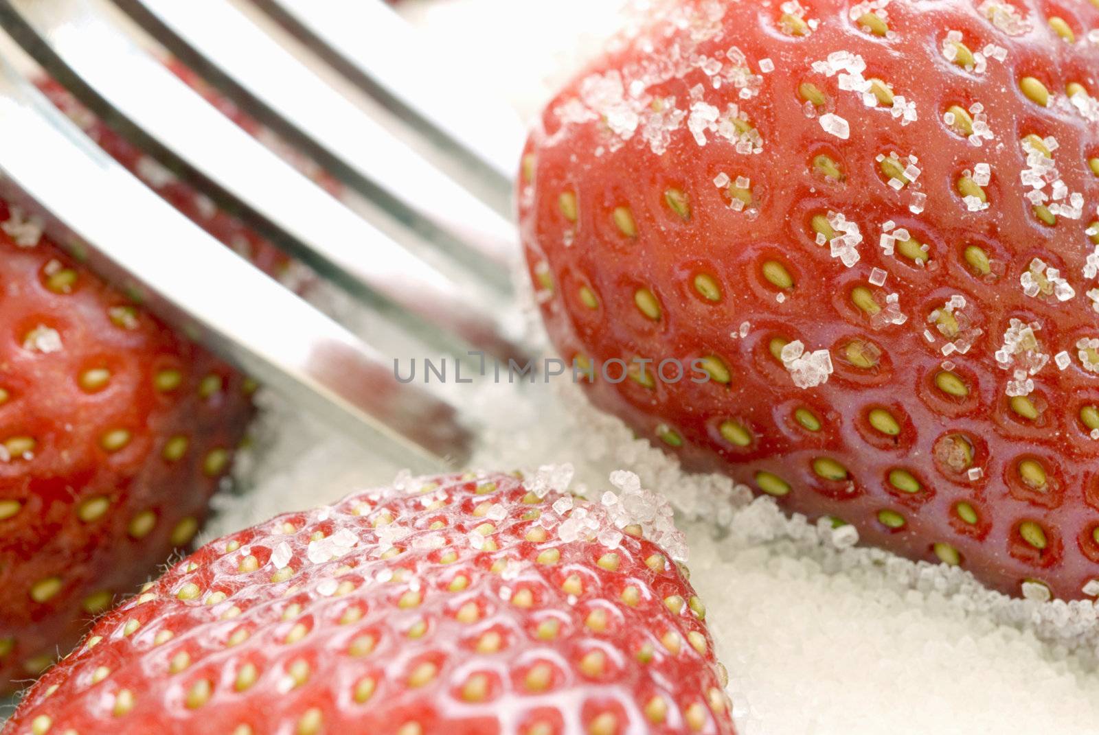 ripe red strawberries coated in sugar granuals